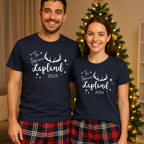 A happy couple wearing matching family Lapland pyjamas, personalised Lapland holiday PJs perfect for a Lapland trip reveal matching outfits. These cosy Christmas Lapland pajamas are shown as a family Lapland pyjama gift idea, styled as personalised Lapland travel PJs within Lapland holiday matching pyjamas sets