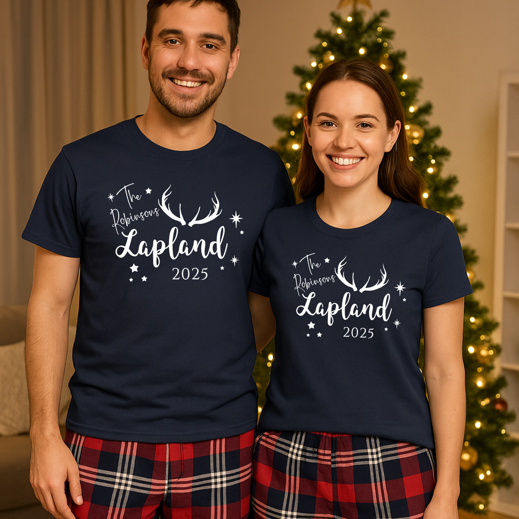 A happy couple wearing matching family Lapland pyjamas, personalised Lapland holiday PJs perfect for a Lapland trip reveal matching outfits. These cosy Christmas Lapland pajamas are shown as a family Lapland pyjama gift idea, styled as personalised Lapland travel PJs within Lapland holiday matching pyjamas sets
