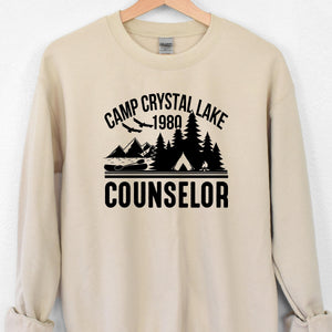 Beige sweatshirt with 'Camp Crystal Lake 1980 Counselor' graphic on a white background