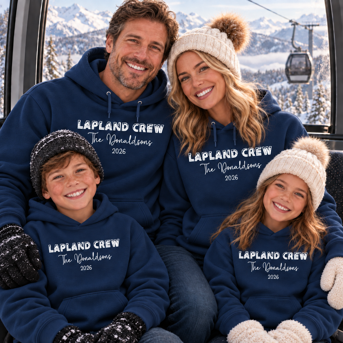 Family wearing matching navy personalised Lapland Crew hoodies inside a snowy mountain cable car