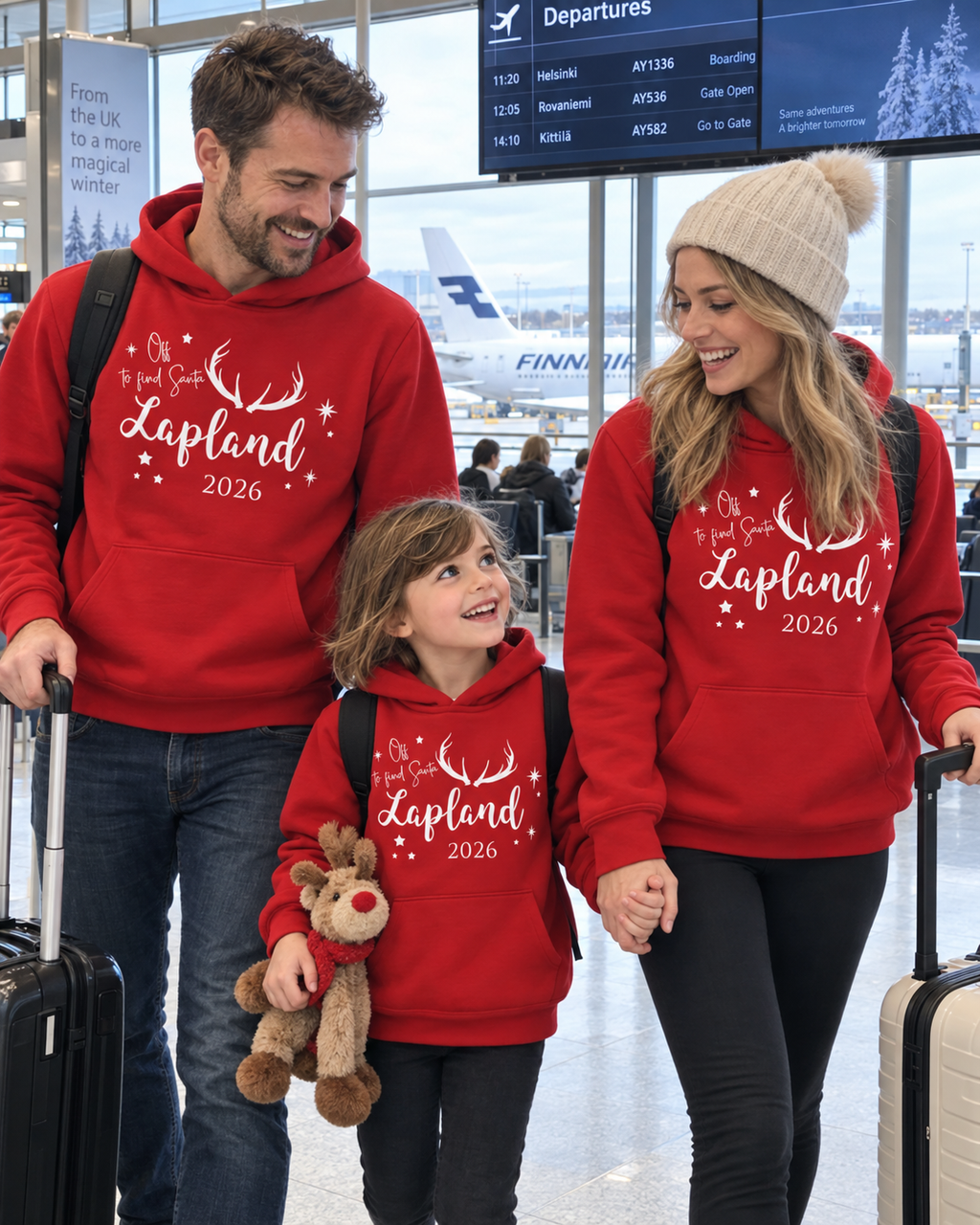 Family wearing matching red Off to Find Santa hoodies at the airport