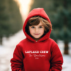 Child wearing a red personalised Lapland Crew hoodie with surname and year