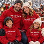 Family wearing matching red personalised Lapland Crew hoodies in the snow