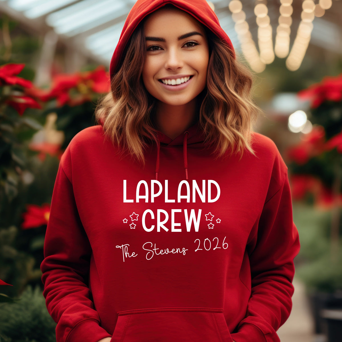 Woman wearing a red personalised Lapland Crew 2026 hoodie