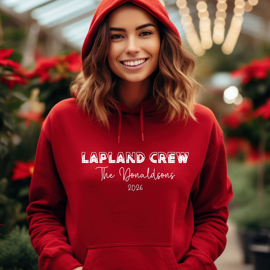 Woman wearing a red personalised Lapland Crew hoodie with family surname and 2026
Family in matching red hoodies	matching-family-lapland-crew-hoodies-red.jpg	Family wearing matching red personalised Lapland Crew hoodies in the snow
Child in red hoodie	childrens-personalised-lapland-crew-hoodie.jpg	Child wearing a red personalised Lapland Crew hoodie with surname and year
Black hoodie product image	black-personalised-lapland-crew-hoodie.jpg	Black personalised Lapland Crew hoodie featuring a family surname an