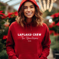 Woman wearing a red personalised Lapland Crew hoodie with family surname and 2026
Family in matching red hoodies	matching-family-lapland-crew-hoodies-red.jpg	Family wearing matching red personalised Lapland Crew hoodies in the snow
Child in red hoodie	childrens-personalised-lapland-crew-hoodie.jpg	Child wearing a red personalised Lapland Crew hoodie with surname and year
Black hoodie product image	black-personalised-lapland-crew-hoodie.jpg	Black personalised Lapland Crew hoodie featuring a family surname an